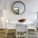 a dining room table with a mirror above it