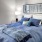 a bed with blue pillows