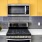 a kitchen with yellow cabinets