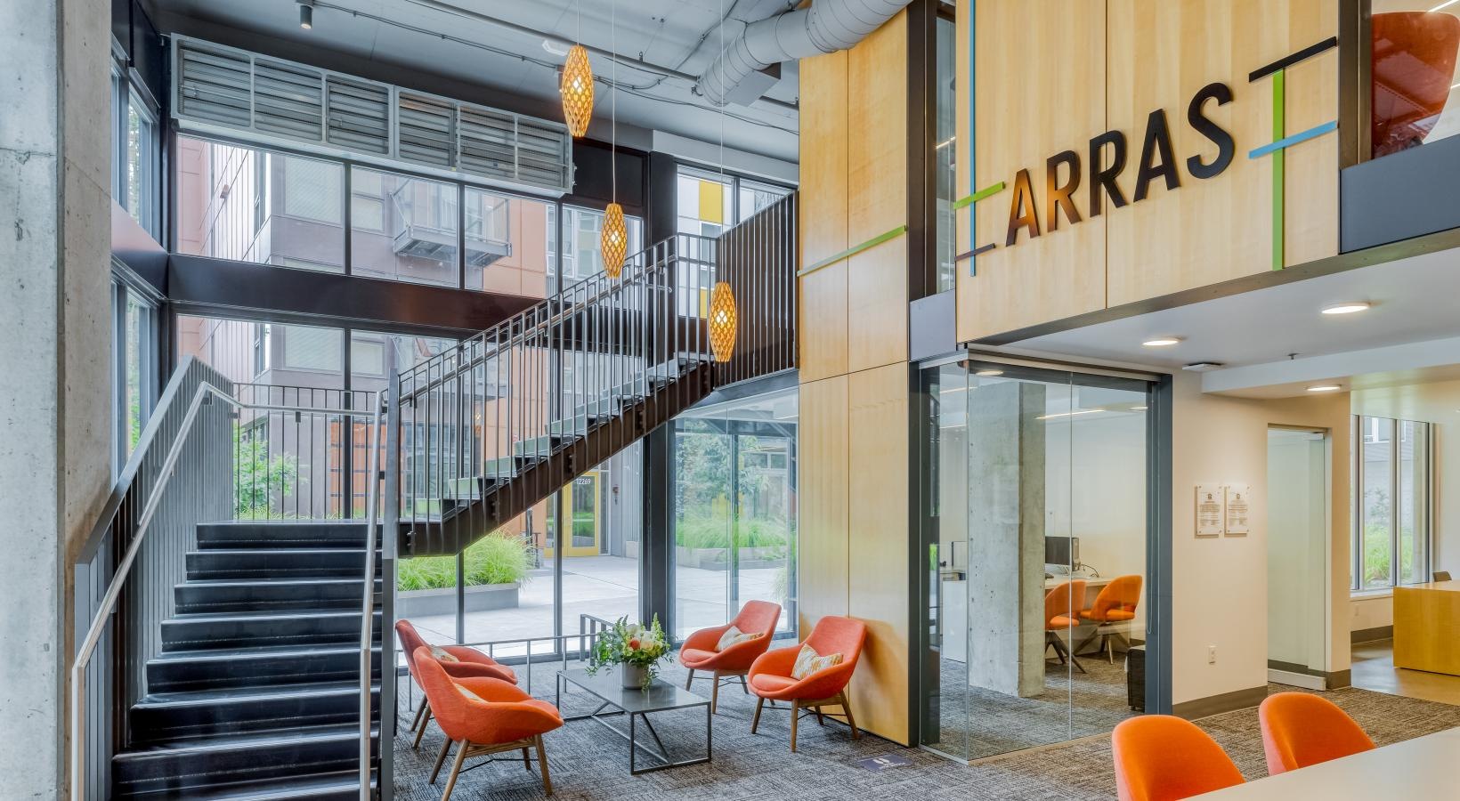Find your perfect fit at Arras a building with orange chairs and a staircase