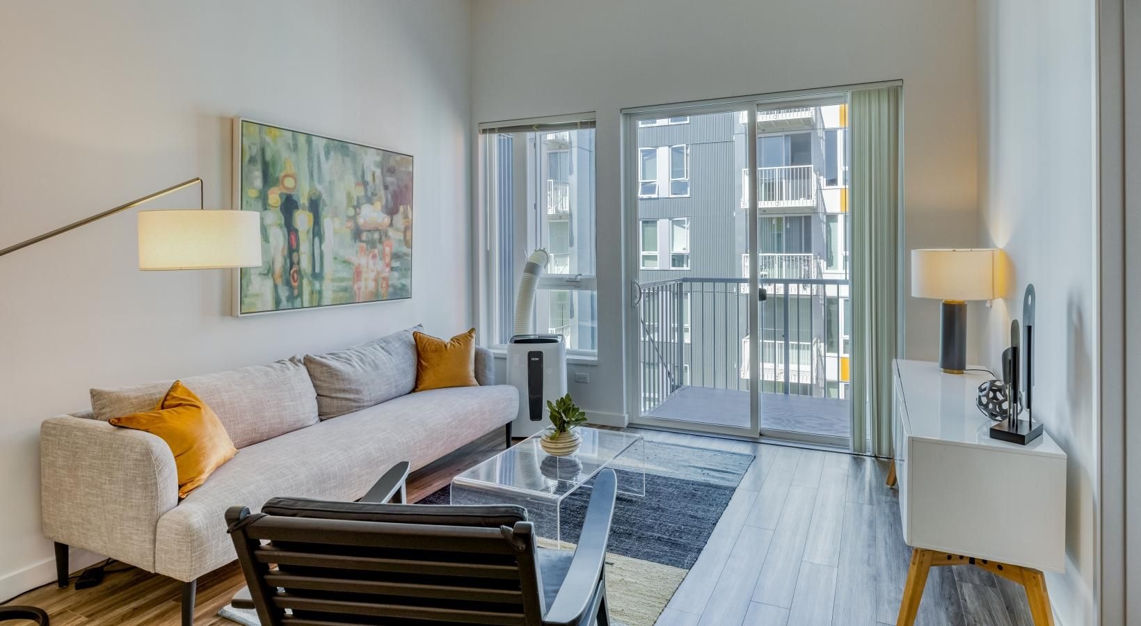Settle into comfort at Arras a living room with a large glass door