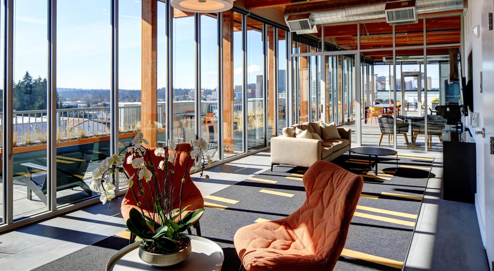 Find your perfect fit at Arras a room with a large glass wall and a large window with a view of the city