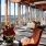 a room with a large glass wall and a large window with a view of the city